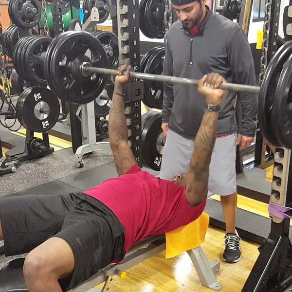 Michael Alessi spotting an athlete on the bench press
